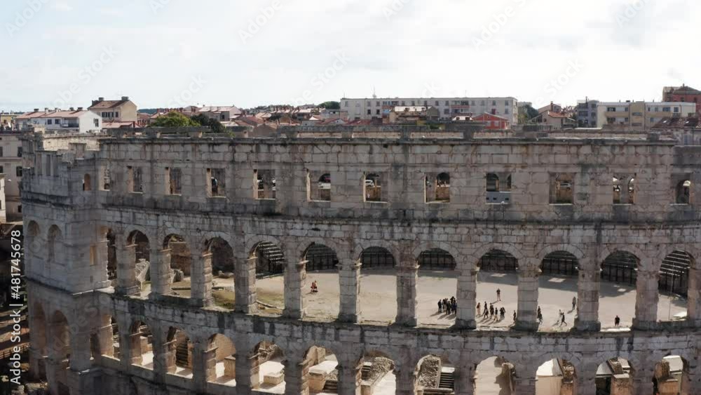 People Inside The Iconic Roman Amphitheatre In The City Of Pula In Istria County, Croatia. Aerial People Inside The Iconic Roman Amphitheatre In The City Of Pula In Istria County, Croatia. Aerial