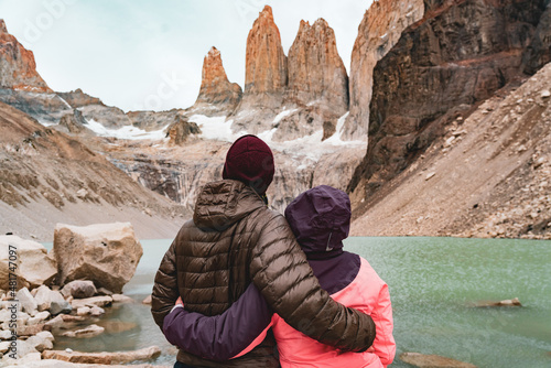 Hiking Couple Look at The three towers of Torres del Paine National Park