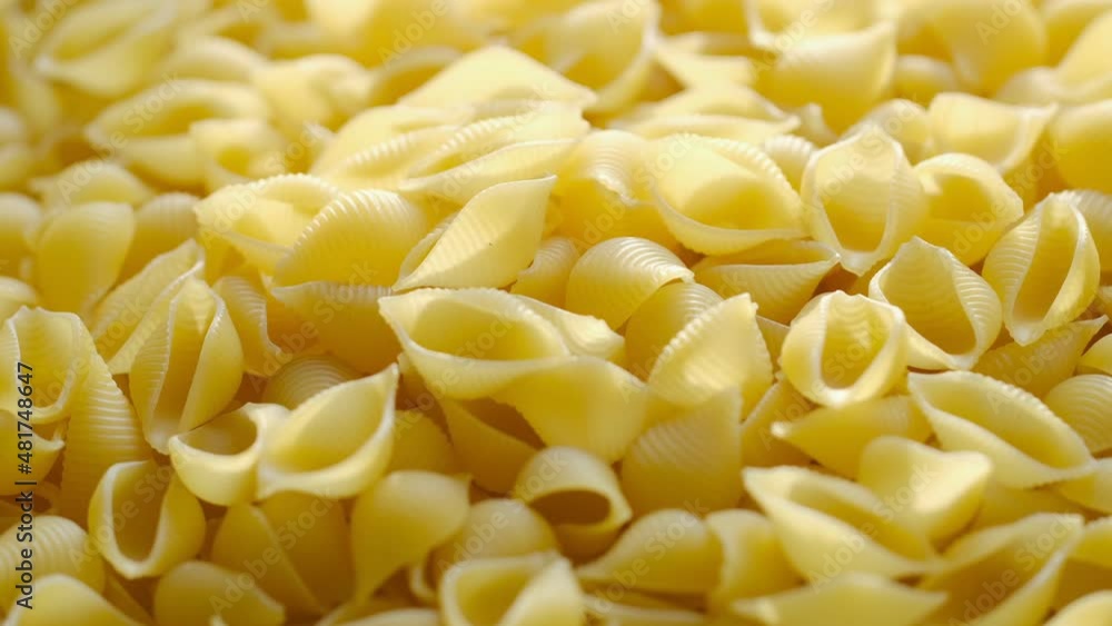Rotating uncooked pasta . Stack of traditional dry raw macaroni. Nobody Rotating uncooked pasta . Stack of traditional dry raw macaroni. Nobody