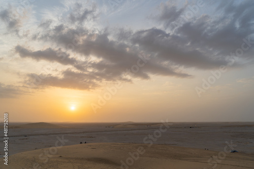 Singing Sand Dune in Qatar during sunset.