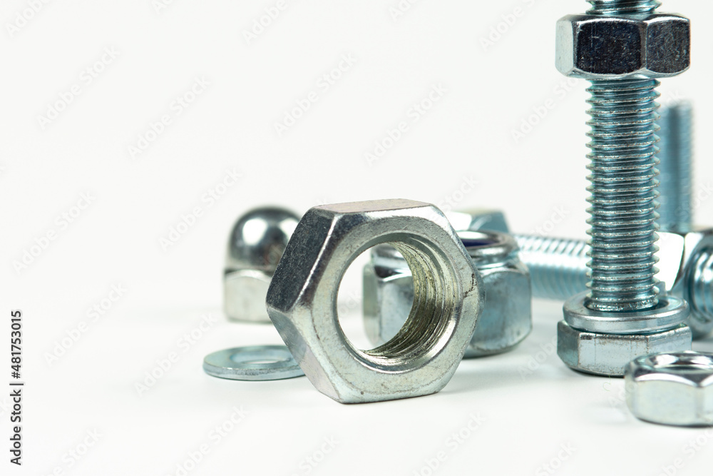 metal bolts and nuts with round washers close-up on a white background metal bolts and nuts with round washers close-up on a white background