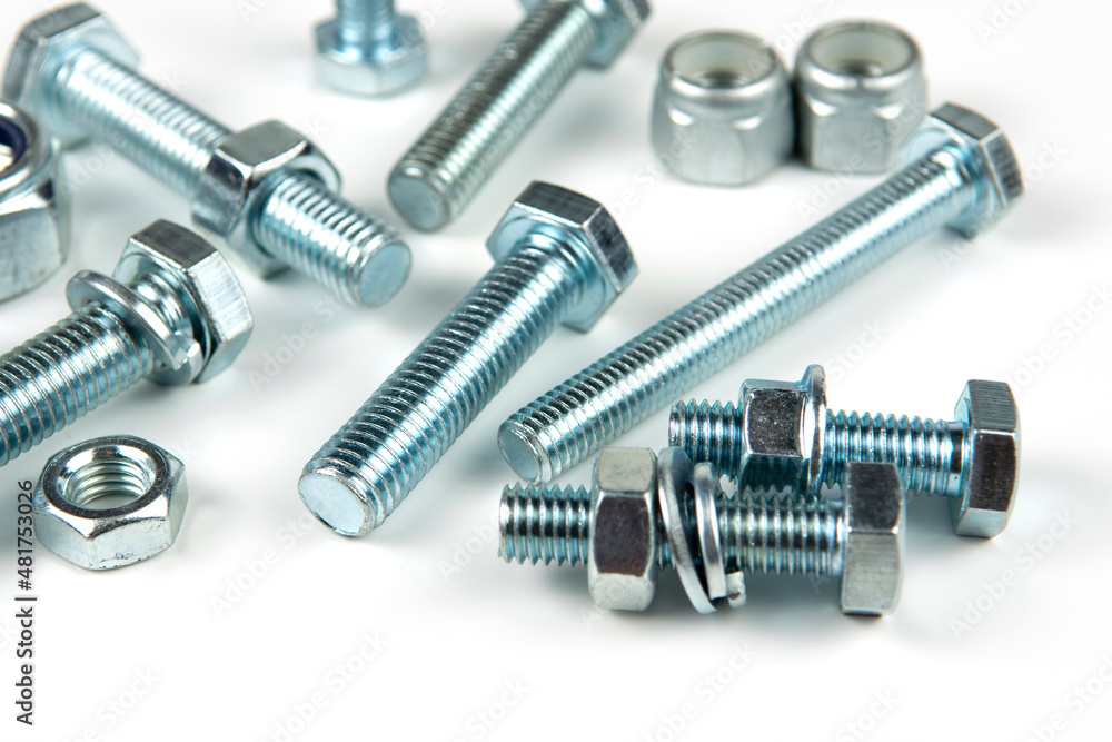 metal bolts and nuts with round washers close-up on a white background metal bolts and nuts with round washers close-up on a white background