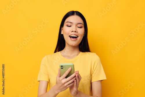 woman with Asian appearance talking on the phone posing technology studio model unaltered