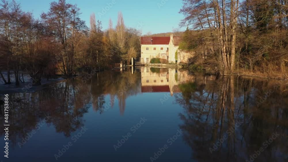 bird fly over a house on a river in normandy bird fly over a house on a river in normandy