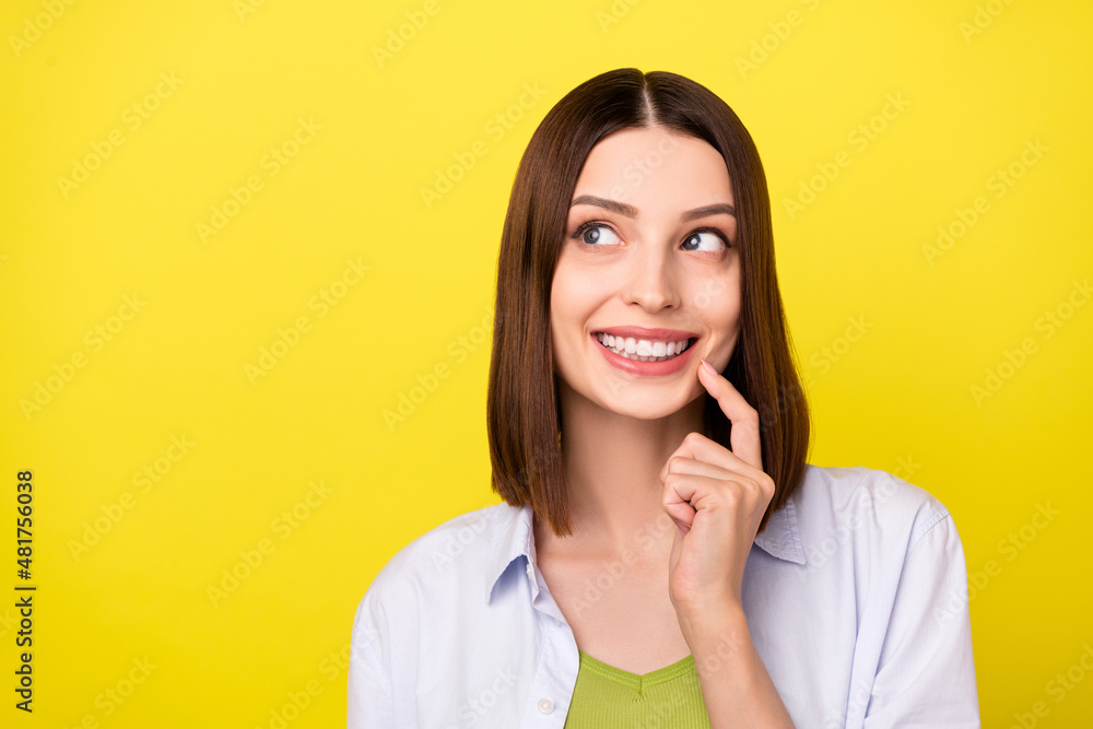 Photo of funny brunette millennial lady look promo wear blue shirt isolated on yellow color background Photo of funny brunette millennial lady look promo wear blue shirt isolated on yellow color background