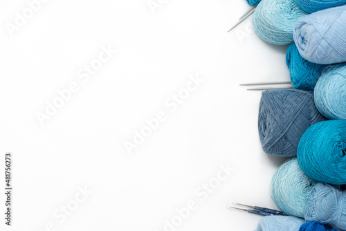 Craft hobby with Vintage knitting needles, yarn ball on white background, still life photo with soft focus. View from above. Handicraft day concept. space text. Crochet background blue Pastel theme.