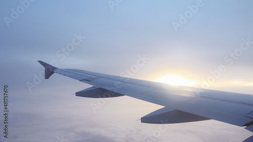 sunset with Wing of an airplane. cloudy sky , Traveling concept with copy space