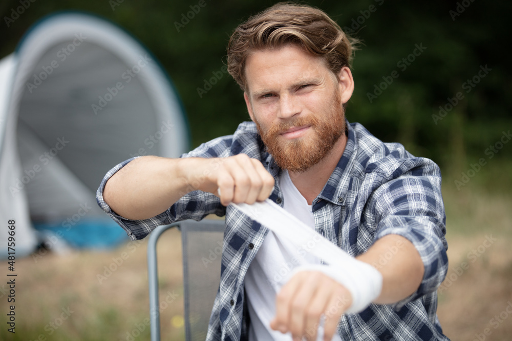 handosme man wrapping his wrist handosme man wrapping his wrist