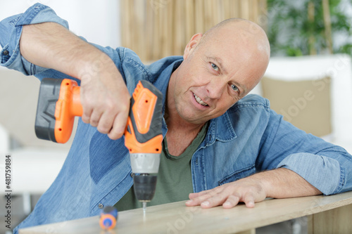 mature man is fixing a furniture photo