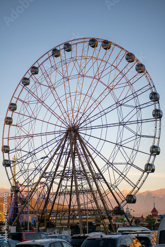 Big Ferris wheel in the rays of sunset.