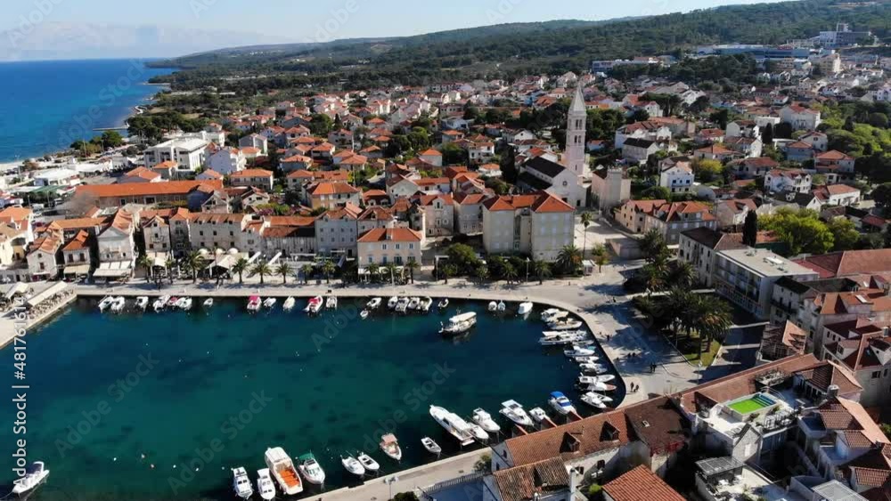 Supetar harbor with church of saint peter, aerial forward. Supetar harbor with church of saint peter, aerial forward.