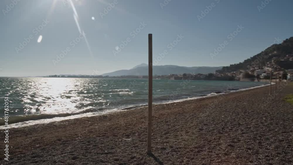 Spinning around a wooden post at wonderful greek shore Spinning around a wooden post at wonderful greek shore
