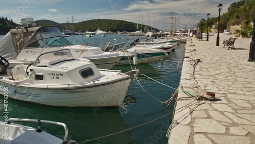 Small fishing boats parked at a turquoise greek bay photo
