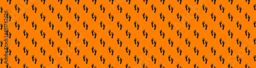 a trace of a man on an orange background. seamless pattern of images of a human footprint on an orange background. Banner for insertion into site.3d rendering.3d image.