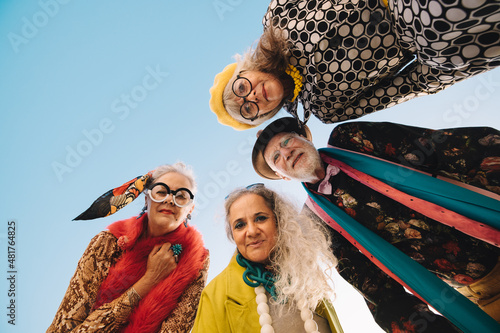 Low angle view of senior citizens having fun and looking at the camera photo