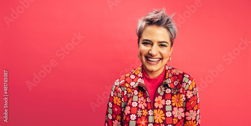 Happy young woman smiling at the camera in a studio