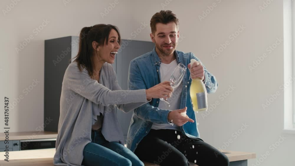 Couple celebrating house ownership with a champagne. Shot with RED helium camera in 8K Couple celebrating house ownership with a champagne. Shot with RED helium camera in 8K
