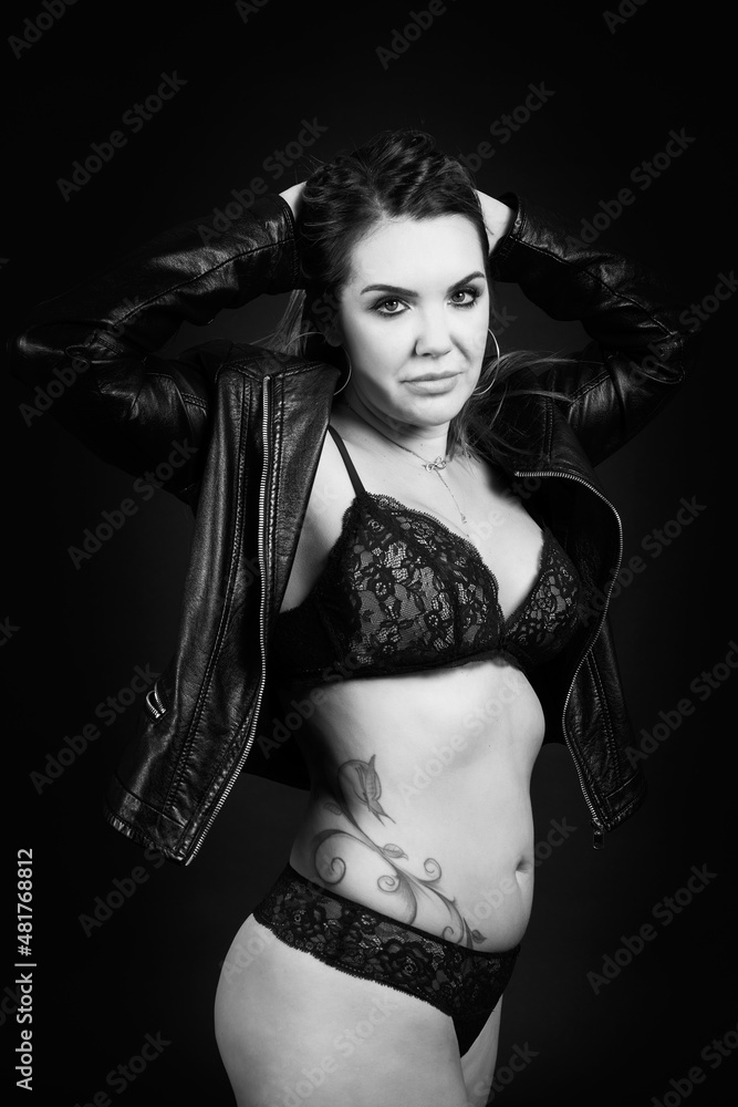 Fototapeta premium pretty young brunette woman posing in lingerie on a black background