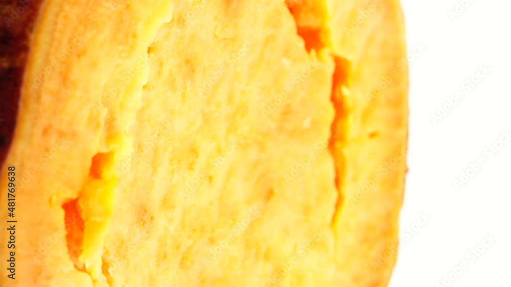 4K Macro shooting of sweet orange yam slices rotating on the turntable. Isolated on the white background. Close-up. Macro. 4K Macro shooting of sweet orange yam slices rotating on the turntable. Isolated on the white background. Close-up. Macro.