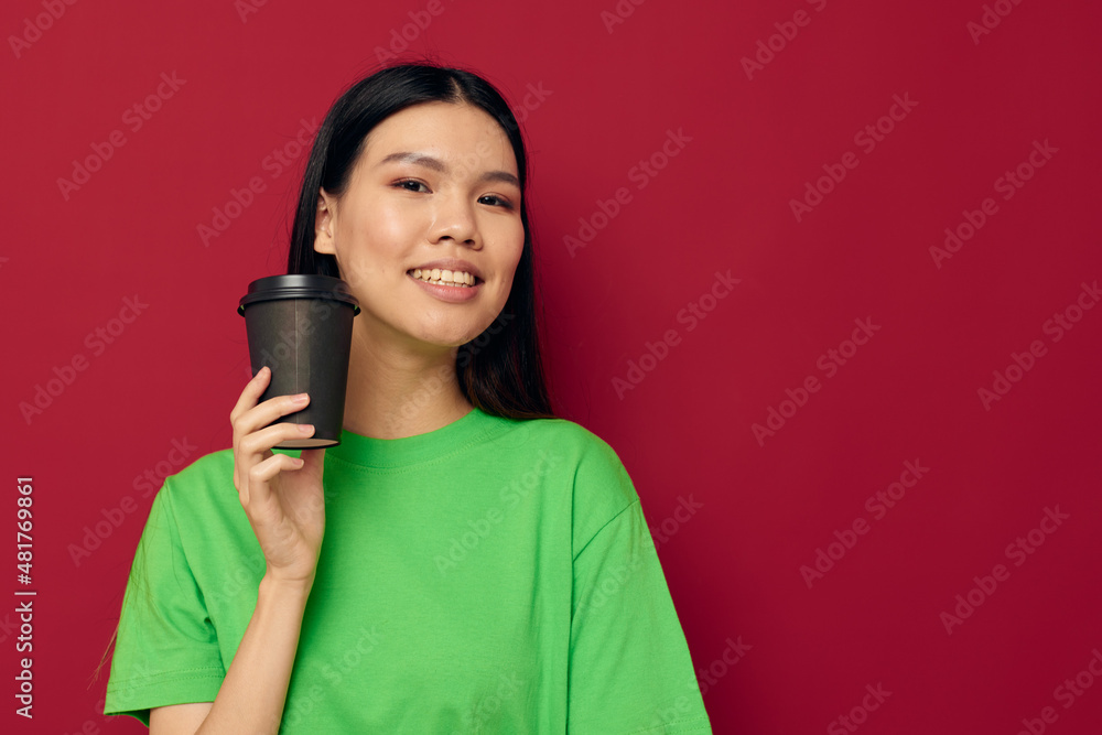 pretty brunette smile green t-shirt black disposable cups fashion studio model unaltered pretty brunette smile green t-shirt black disposable cups fashion studio model unaltered
