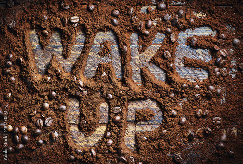 Wake up with coffee sign on wooden table