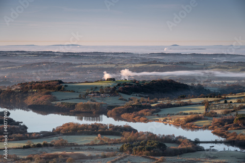 Panoramic view of Tittesworth Reservoir from The Roaches, with the Long Mynd, and The Wrekin in the distance at sunrise in the Peak District National Park, UK. photo