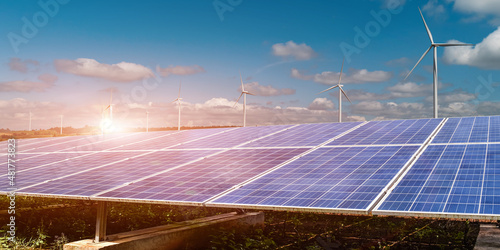 Solar panel with wind turbine against sunset sky background. Photovoltaic, alternative electricity source. sustainable resources concept. © banphote