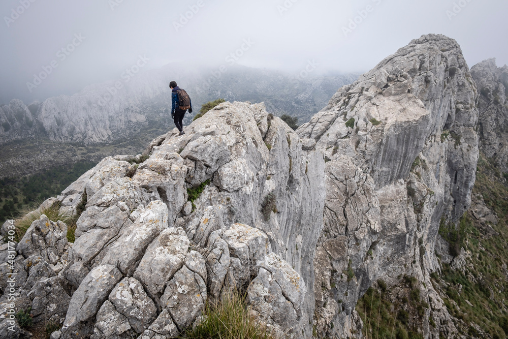 lonely mountaineer on the edge of Son Torrella sierra, Fornalutx, Mallorca, Balearic Islands, Spain