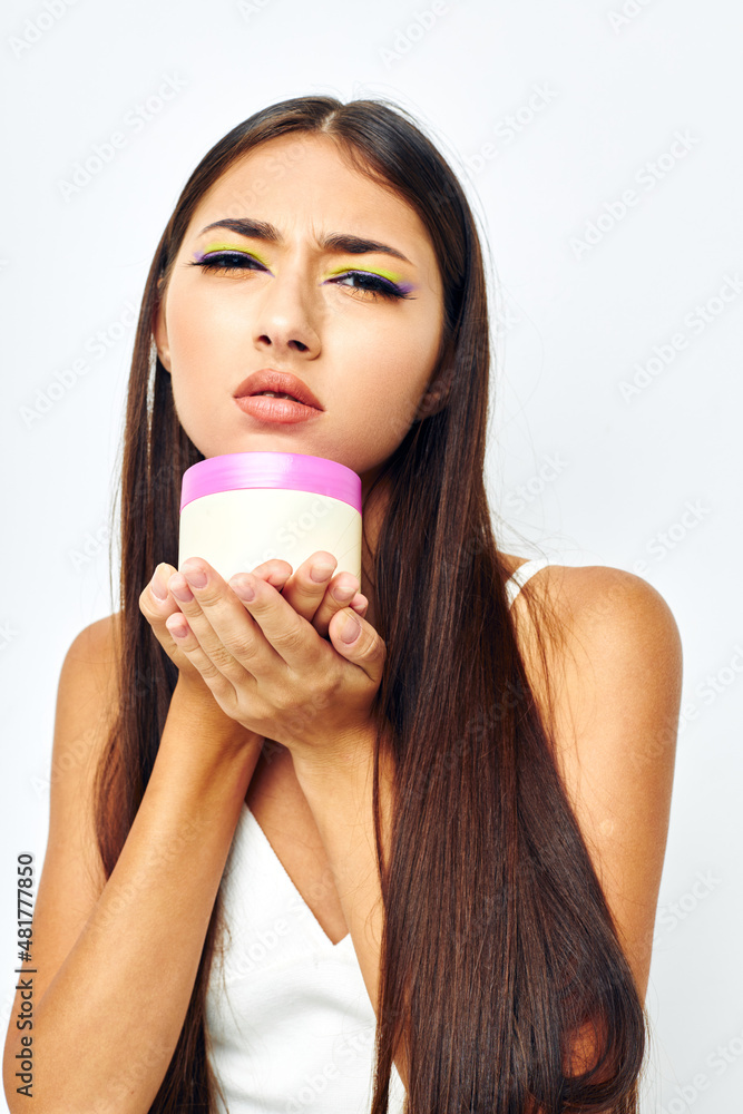 portrait pretty woman posing cream jar cosmetics isolated background unaltered portrait pretty woman posing cream jar cosmetics isolated background unaltered