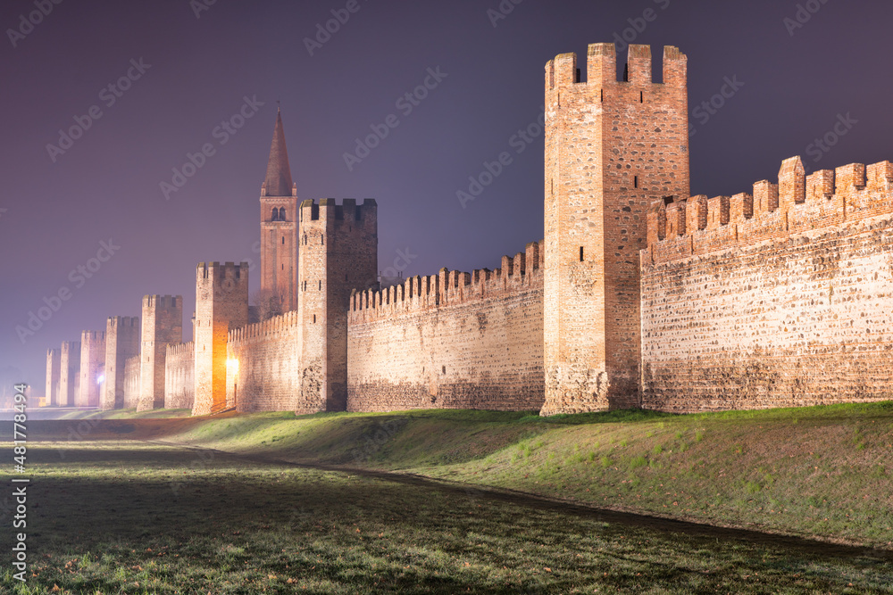view of the defensive wall of Montagnana in Veneto, Italy on a foggy night