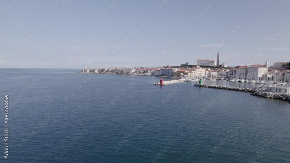Video with a drone of a rear aerial shot over the city of Piran in Slovenia, it begins advancing through the port and ends up ascending over the city in a aerial shot just above the central square. Video with a drone of a rear aerial shot over the city of Piran in Slovenia, it begins advancing through the port and ends up ascending over the city in a aerial shot just above the central square.