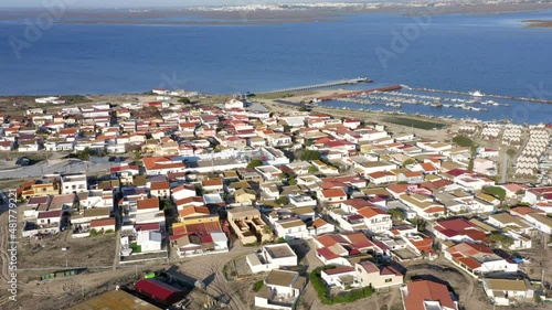 Coastal Buildings And Marina In Culatra Island, Located In The Ria Formosa, Algarve Region Of Portugal. aerial