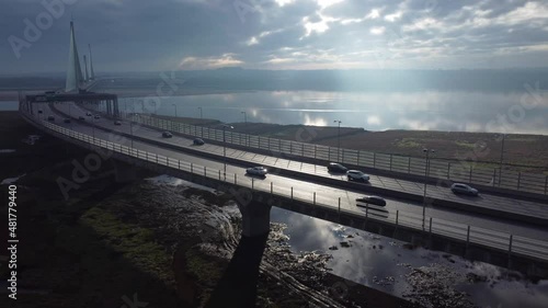 Wallpaper Mural Mersey Gateway cable suspension bridge with sunrise reflections in river landmark aerial view slow right pan over traffic Torontodigital.ca