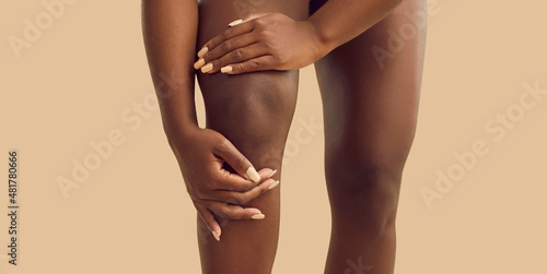 Crop close up of African American woman struggle with acute pain in kneecap. Pain in knee concept. Unwell black biracial female suffer from ache in leg have arthritis or osteoarthrosis.