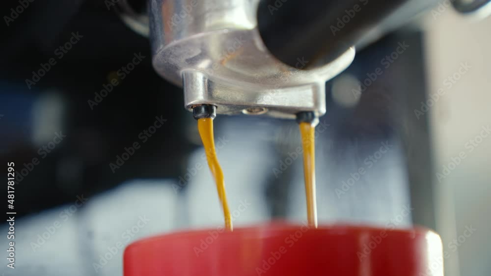 Coffee Streamflow UHD 4k Slow motion B Roll of Pouring coffee stream from machine in cup ...