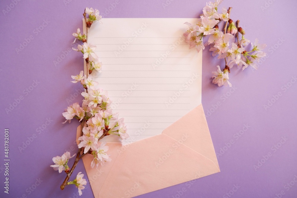 Spring greeting concept. Blank card decoration with Cherry blossoms on purple background. Spring, wedding, event background.