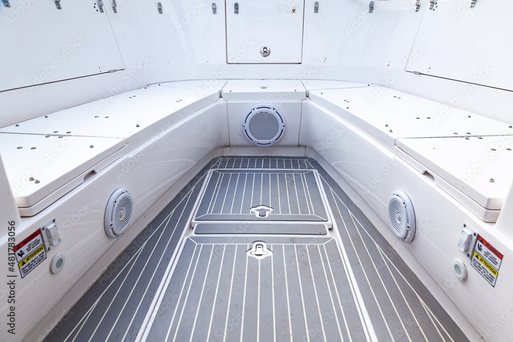 Fototapeta premium Part of the yacht's teak deck with closed escape hatches to the yacht's cabins and acoustic speakers built into the boat's hull.