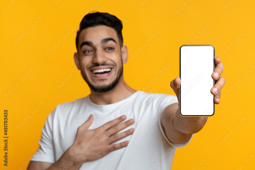 Closeup of excited middle-eastern man showing smartphone with empty screen Closeup of excited middle-eastern man showing smartphone with empty screen