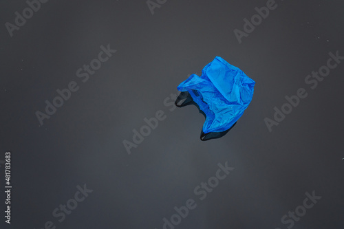blue plastic bag swimming on water
