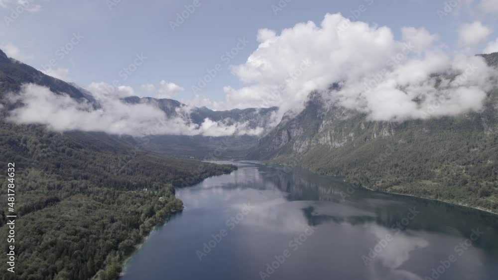 Frontal drone video over Lake Bohinj advancing towards its interior between the mountains, the sky is clear with some clouds. Frontal drone video over Lake Bohinj advancing towards its interior between the mountains, the sky is clear with some clouds.
