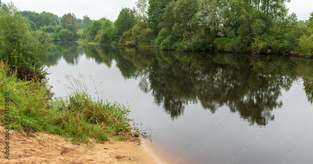 Daylight on a river, trees reflection in water. Summer landscape Daylight on a river, trees reflection in water. Summer landscape