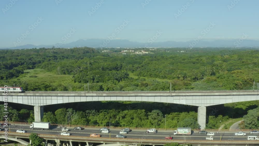 Aerial flying forward crossing subway line and traffic, outskirts of Santo Domingo Aerial flying forward crossing subway line and traffic, outskirts of Santo Domingo