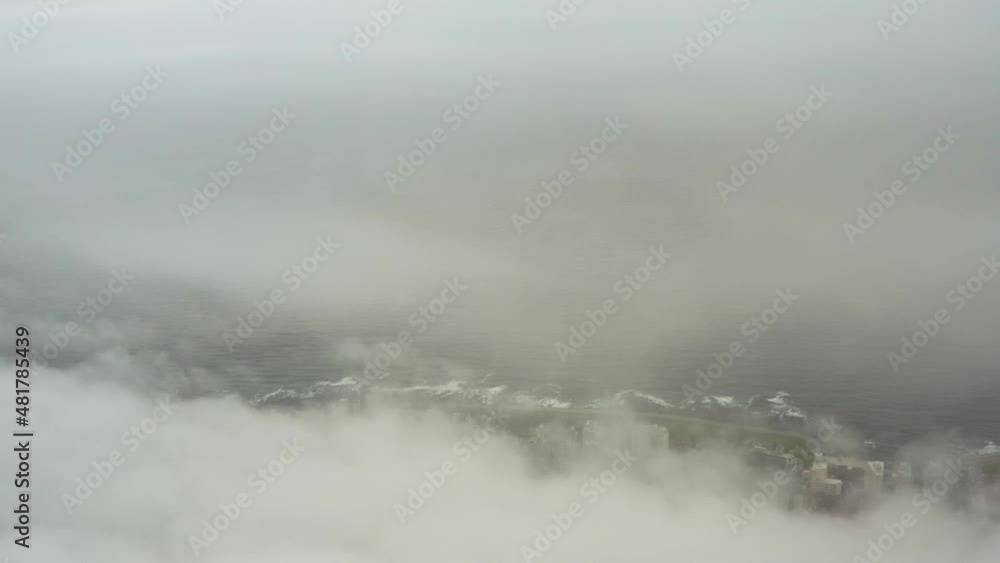 Long aerial shot flying through clouds and revealing the coastline of Cape Town, South Africa Long aerial shot flying through clouds and revealing the coastline of Cape Town, South Africa