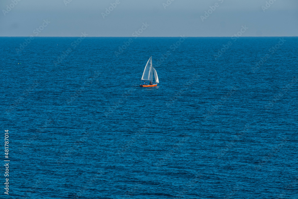Sailing boats cross the waters of the island of Tabarca, in the Spanish Mediterranean, in front of Santa Pola, Alicante