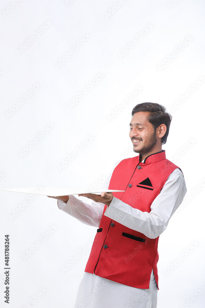 Young indian farmer in traditional wear and giving expression on white background. Young indian farmer in traditional wear and giving expression on white background.