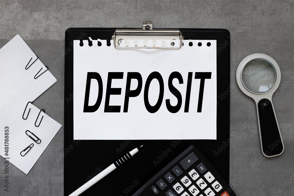 Deposit. black clipboard, with a white sheet of paper on a gray background. calculator. magnifying glass. business concept Deposit. black clipboard, with a white sheet of paper on a gray background. calculator. magnifying glass. business concept