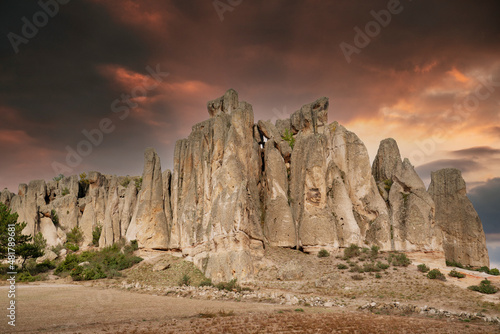 Historical ancient Frig vadisi (Phrygia, Gordion Valley). Houses, structures carved into rocks. Frig Valley is popular tourist attraction in the Ayazini, Afyon–Turkey. Sunset scenery in the background