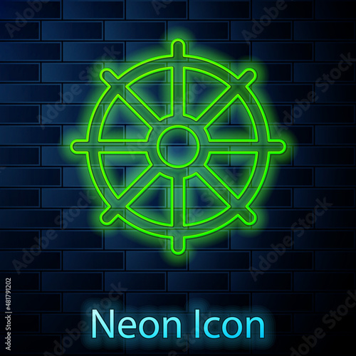 Glowing neon line Dharma wheel icon isolated on brick wall background. Buddhism religion sign. Dharmachakra symbol. Vector
