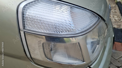 Foggy headlight with condensation in a modern car