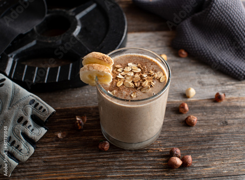 Body building snack for muscle gain. Pre workout shake with chocolate whey protein, oat flakes, bananas and hazelnuts